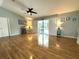 Bright and airy living space showcasing hardwood floors and a view of the screened-in pool area at 713 Rustic Oaks Dr, Palm Harbor, FL 34684