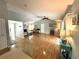 Spacious living room boasts gleaming hardwood floors, vaulted ceilings, and slider access to the screened-in pool at 713 Rustic Oaks Dr, Palm Harbor, FL 34684