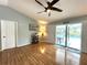 Bright living room featuring wood floors, access to the pool area, vaulted ceiling, and neutral paint at 713 Rustic Oaks Dr, Palm Harbor, FL 34684