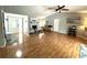 Large living room featuring an open floor plan, fireplace, wood floors, and access to other living areas at 713 Rustic Oaks Dr, Palm Harbor, FL 34684
