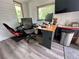 A functional home office space with multiple monitors and a comfortable ergonomic chair at 713 Rustic Oaks Dr, Palm Harbor, FL 34684