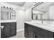 Upscale bathroom with dual vanities, marble countertops, modern fixtures, and elegant lighting at 7607 New York Ave, Hudson, FL 34667