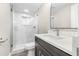 Modern bathroom featuring a glass shower, a vanity with a marble countertop, and sleek fixtures at 7607 New York Ave, Hudson, FL 34667