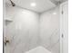 Modern bathroom showcasing pristine white tile walls and shower head at 7607 New York Ave, Hudson, FL 34667