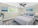 This bedroom features a bright window, ceiling fan, and calming wall decor at 7607 New York Ave, Hudson, FL 34667