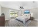 Bedroom showcasing gray wood-look flooring and a sliding glass door with pool access at 7607 New York Ave, Hudson, FL 34667