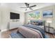 Comfortable bedroom featuring plush bedding, modern furniture, and bright window view at 7607 New York Ave, Hudson, FL 34667