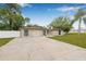 Charming single-story home featuring a stone facade, attached garage, and a spacious driveway at 7607 New York Ave, Hudson, FL 34667