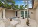 Welcoming front entrance with decorative stone, white rock landscaping, and a palm tree at 7607 New York Ave, Hudson, FL 34667