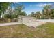 Detached garage with ample parking space in a large backyard and partial fencing at 7607 New York Ave, Hudson, FL 34667