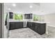 Bright kitchen with stainless steel appliances, modern cabinets, and subway tile backsplash at 7607 New York Ave, Hudson, FL 34667