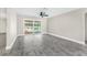 Open floor plan living room with sliding glass doors providing views of the pool at 7607 New York Ave, Hudson, FL 34667