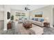 Bright living room with sliding glass doors to backyard, plush seating, and modern decor at 7607 New York Ave, Hudson, FL 34667