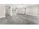 Large living area featuring new floors and arches to transition between rooms at 7607 New York Ave, Hudson, FL 34667