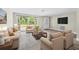 Inviting living room with large window, comfortable seating, and stylish decor at 7607 New York Ave, Hudson, FL 34667