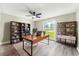 Home office featuring desk, stylish bookshelves, and large window with outdoor view at 7607 New York Ave, Hudson, FL 34667