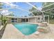 Beautiful screened-in pool with rock waterfall feature and spacious patio at 7607 New York Ave, Hudson, FL 34667