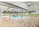 Covered and screened-in pool with an open patio area for entertaining guests at 7607 New York Ave, Hudson, FL 34667