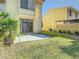 Cozy backyard with a small patio and lush green lawn, ideal for relaxing and enjoying the outdoors at 9027 Pebble Creek Dr, Tampa, FL 33647