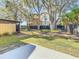 Backyard with lawn and mature shade trees at 9027 Pebble Creek Dr, Tampa, FL 33647