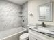 Bathroom features a bathtub with shower, toilet, and sink with vanity at 9027 Pebble Creek Dr, Tampa, FL 33647