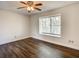 Bright bedroom featuring wood floors, a ceiling fan, and natural light at 9027 Pebble Creek Dr, Tampa, FL 33647