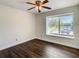 Bedroom features a window and closet with new flooring at 9027 Pebble Creek Dr, Tampa, FL 33647