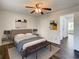 Spacious bedroom featuring wood floors, ceiling fan, area rug, and ensuite bathroom access at 9027 Pebble Creek Dr, Tampa, FL 33647