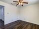 Empty bedroom features modern ceiling fan, and new dark wood flooring at 9027 Pebble Creek Dr, Tampa, FL 33647