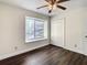 Bedroom features a window and closet with new flooring at 9027 Pebble Creek Dr, Tampa, FL 33647