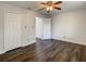 Bright bedroom with hardwood floors, ceiling fan, and closet access at 9027 Pebble Creek Dr, Tampa, FL 33647