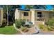Inviting townhome with a quaint balcony and attractive landscaping, showcasing a welcoming facade at 9027 Pebble Creek Dr, Tampa, FL 33647