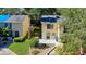 Aerial view of a cozy townhome with well-kept lawn, sidewalk, and green surroundings, highlighting its appeal at 9027 Pebble Creek Dr, Tampa, FL 33647
