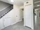 Hallway with stairwell and tile flooring, featuring a closet and entryway at 9027 Pebble Creek Dr, Tampa, FL 33647