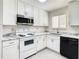 Bright kitchen featuring white cabinets, stainless steel appliances, and tile flooring, a modern and clean design at 9027 Pebble Creek Dr, Tampa, FL 33647