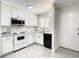 Bright kitchen featuring white cabinets, stainless steel appliances, and tile flooring, a modern and clean design at 9027 Pebble Creek Dr, Tampa, FL 33647