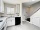 Bright kitchen featuring white cabinets, stainless steel appliances, and tile flooring, a modern and clean design at 9027 Pebble Creek Dr, Tampa, FL 33647