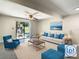 Bright living room with modern seating arrangement and sliding doors to patio at 9027 Pebble Creek Dr, Tampa, FL 33647