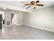 Spacious living room with tile flooring, ceiling fan, and neutral walls at 9027 Pebble Creek Dr, Tampa, FL 33647