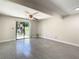Open living room with sliding glass doors that provide outdoor access and light at 9027 Pebble Creek Dr, Tampa, FL 33647