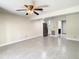 Open living room with tile flooring and view into kitchen at 9027 Pebble Creek Dr, Tampa, FL 33647