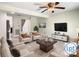 Inviting living room with plush seating, a ceiling fan, and a decorative TV at 9027 Pebble Creek Dr, Tampa, FL 33647