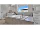 Close up of soaking tub and fixtures in well-lit bathroom with view from window at 9456 Channing Hill Dr, Sun City Center, FL 33573