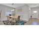 Bright dining room with tile floors, modern chandelier, stylish rug, and neutral wall color at 9456 Channing Hill Dr, Sun City Center, FL 33573