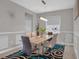 Contemporary dining room featuring a modern light fixture, stylish rug, and neutral wall color at 9456 Channing Hill Dr, Sun City Center, FL 33573