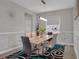 Contemporary dining room featuring a modern light fixture, stylish rug, and neutral wall color at 9456 Channing Hill Dr, Sun City Center, FL 33573
