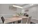 Bright dining room featuring modern lighting, a large table, and seating for comfortable Gathering meals at 9456 Channing Hill Dr, Sun City Center, FL 33573