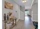 Inviting foyer with tile floors, elegant decor, and a view of the staircase and sliding glass doors at 9456 Channing Hill Dr, Sun City Center, FL 33573