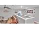 Upstairs hallway with sitting area and a view into a bedroom at 9456 Channing Hill Dr, Sun City Center, FL 33573