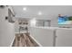 Upstairs hallway with wood floors, neutral walls, and decorative elements at 9456 Channing Hill Dr, Sun City Center, FL 33573